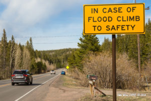 Road sign: In case of flood climb to safety! (Copyright image, 2018.)
